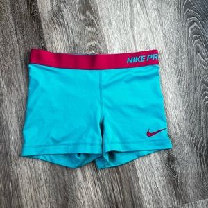 Blue and pink Nike pros